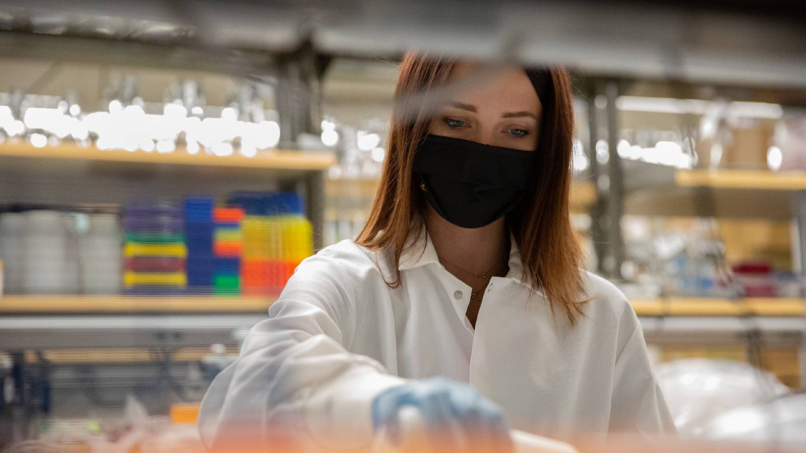 Female student researcher working in a lab.